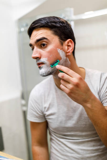 istock A man is shaving in the bathroom with a disposable razor. 1439861686