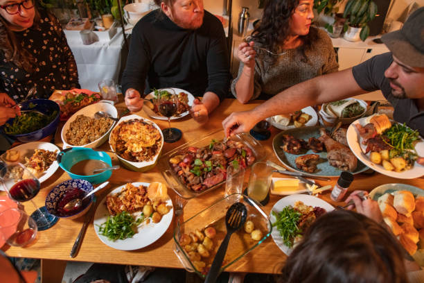 High Angle View of Loaded Table at Friendsgiving Dinner Party