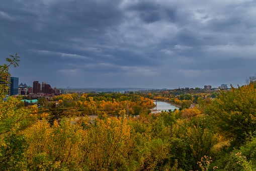 A panoramic view of the fall river valley in Calgary under a moody sky.