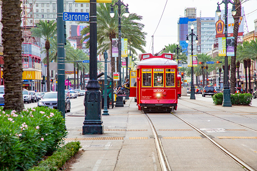 New Orleans, USA - July 17, 2013:  people travel with the famous old Street car St. Charles line in New Orleans, USA.  It is the oldest continually operating street car line in the world.