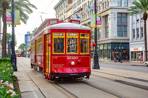 New Orleans, USA - July 17, 2013:  people travel with the famous old Street car St. Charles line in New Orleans, USA.  It is the oldest continually operating street car line in the world.