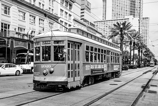 New Orleans, USA - July 16, 2013:   people travel with the old Street car Canal street line St. Charles line in New Orleans, USA.  It is the oldest continually operating street car line in the world.