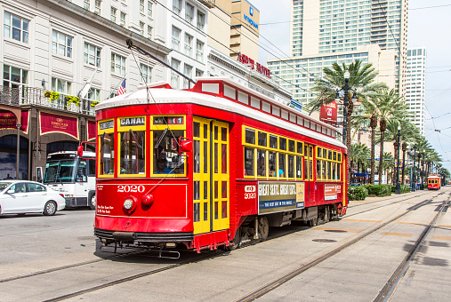 New Orleans, USA - July 16, 2013:   people travel with the old Street car Canal street line St. Charles line in New Orleans, USA.  It is the oldest continually operating street car line in the world.