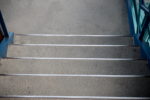 A close up of concrete stairs with stark shadows