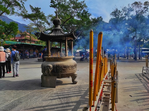 Ngong Ping, Hong Kong. October 30,2022 : Incense burning for prayer in front of Po Lin monastery, Ngong Ping, Lantau island Hong Kong