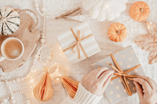 istock Autumn flat lay composition. Warm comfort sweater, pumpkins, gift boxes, dried leaves. Thanksgiving, fall, slow living concept. Top view, copy space 1439870313