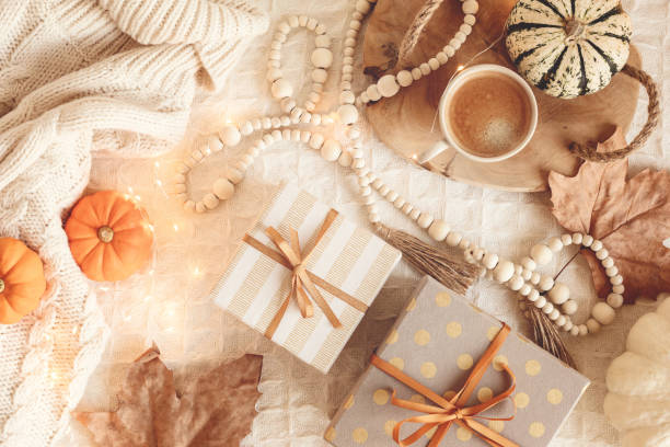 istock Autumn flat lay composition. Warm comfort sweater, pumpkins, gift boxes, dried leaves. Thanksgiving, fall, slow living concept. Top view, copy space 1439870422