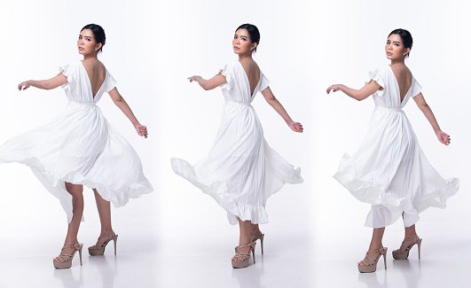 Full length 20s Asian Woman wear white relax wedding dress farmer high heel shoes. Black long straight hair female feel happy smile fashion vintage poses 360 front back over white background isolated