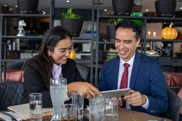 istock executives at meeting, viewing the tablet 1439873344