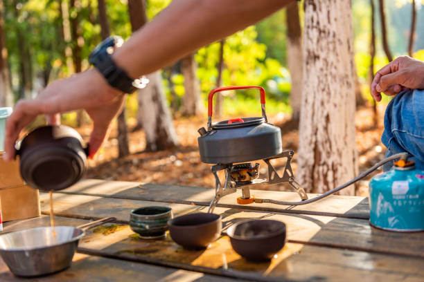 istock Man's hand holding tea cup and pouring tea 1439875099