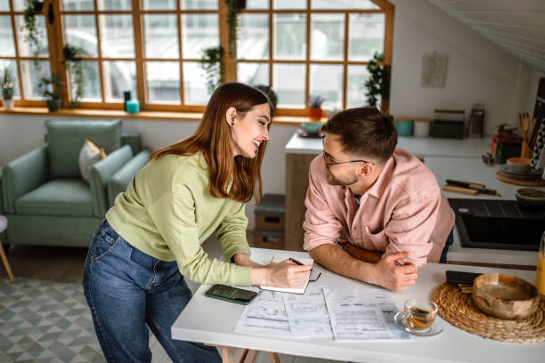 istock Young couple going through their home financial bills at home 1439880265