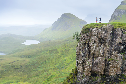 Beautiful,dramatic Scottish, Skye mountain scenery,jagged peaks,winding road and sheer cliffs, along the Quiraing hills walk,green course grass covered in mid summer,in the north east.