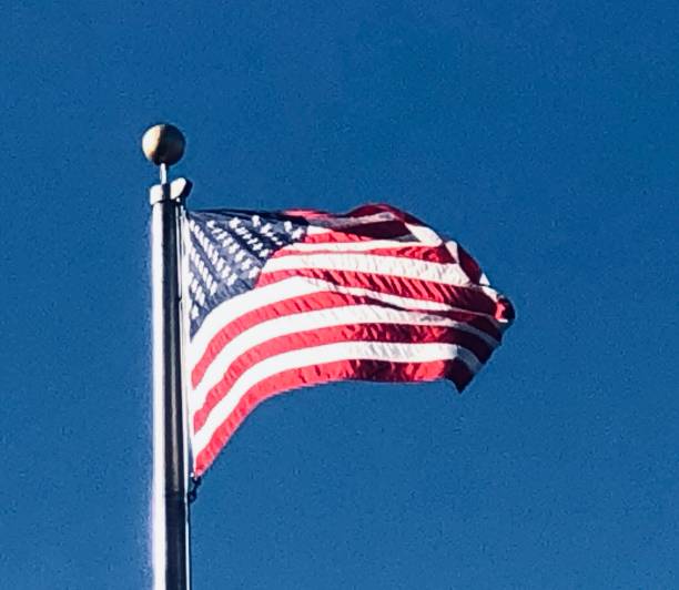 istock Blue Sky and American Flag 1439887483