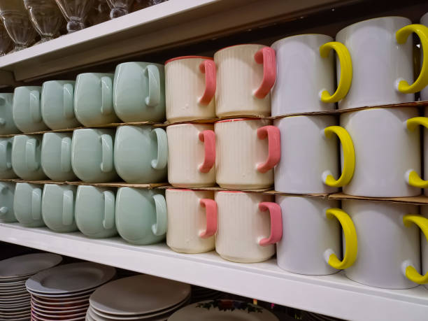 istock Rows of mugs neatly arranged on a display shelf. 1439888345
