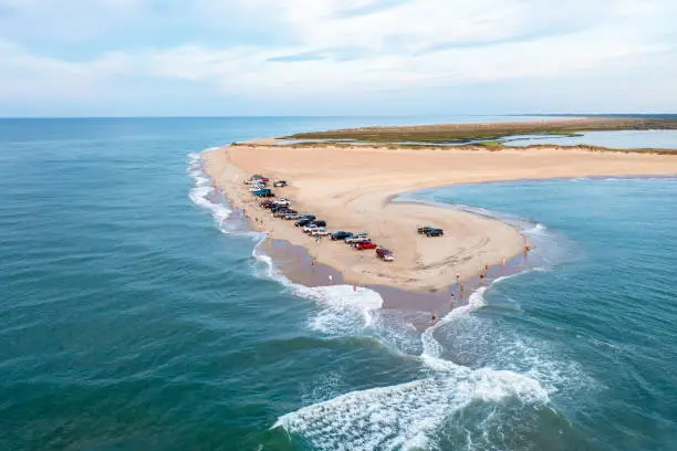 Photo of Aerial View of trucks on the beach and people fishing at Cape Point in Hatteras North Carolina