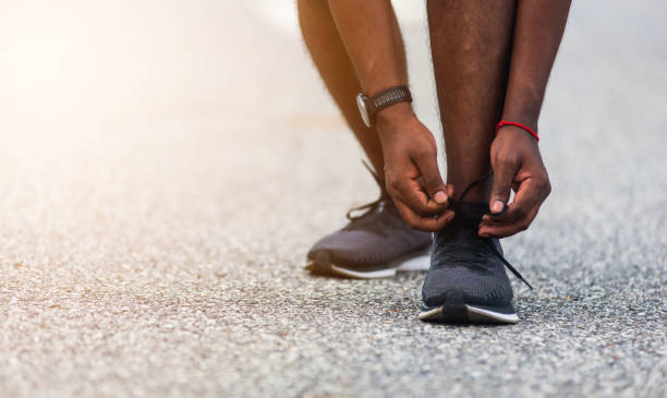 istock runner black man standing he trying shoelace running shoes 1439894571