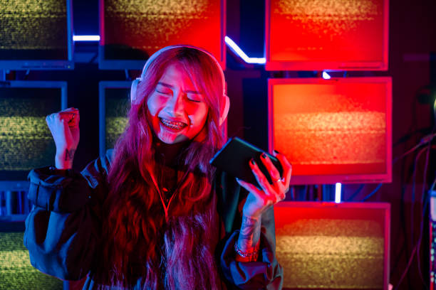 istock Young woman feeling excited at gaming room 1439894592