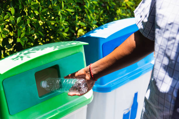 istock black hand throwing an empty plastic water bottle in the recycling garbage trash 1439894658