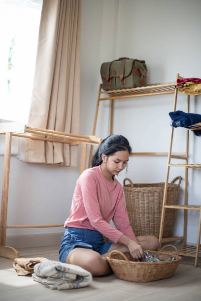 istock woman folding clothes in closet 1439894788