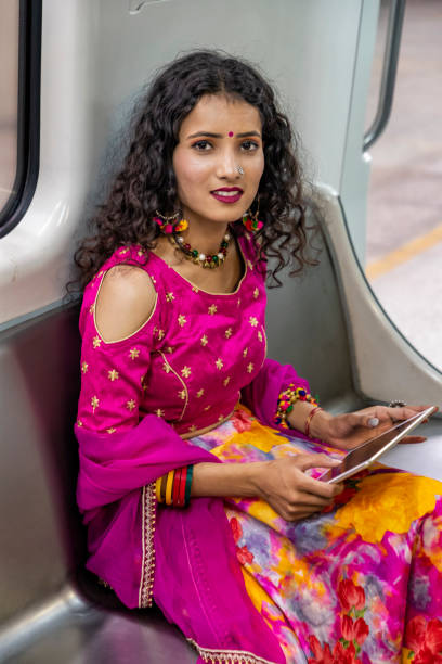 istock Young woman using a digital tablet in a subway train, India 1439895459