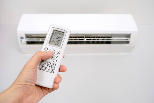 istock Man's hand using remote control open The air conditioner is cooled to 25 degrees Celsius in his bedroom. Health concepts and energy savings 1439895853