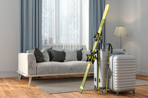 Close-up View Of Luggages And Ski In Living Room With Blurred Background. Winter Holiday Concept