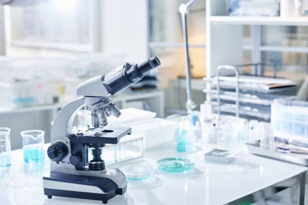 istock Workplace of virologist or other scientist with microscope and glassware 1439899831