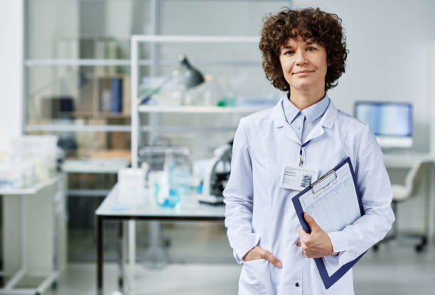 istock Young confident clinician with document in clipboard standing in laboratory 1439901422
