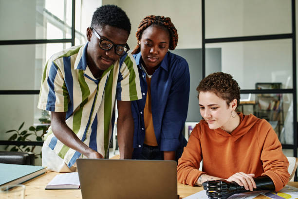 istock Young African American employee pointing at laptop screen 1439908141