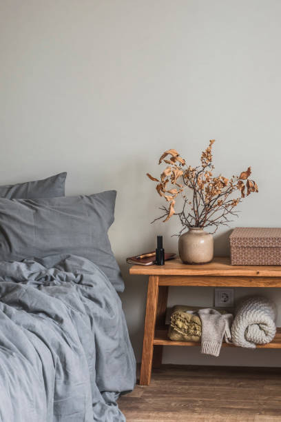 istock Bedroom interior - bed, bench with autumn decor. Cozy Scandinavian style interior 1439908374