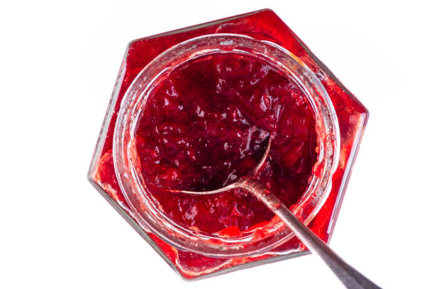 istock Jar of strawberry jam with spoon 1439909641