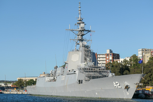 HMAS Sydney docked at Garden Island, Sydney Harbour, is one of three Hobart Class destroyers of the Royal Australian Navy.   This image was taken on a sunny afternoon in Spring.