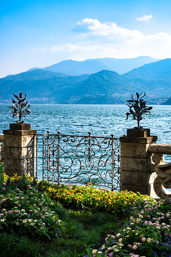 Majestic views of Lake Como and European Alps visible from the botanical garden of Villa Monastero, in the old traditional village of Varenna, Province of Lecco, Italy.
