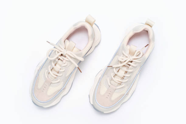 Pair of sneakers on white background close-up top view.