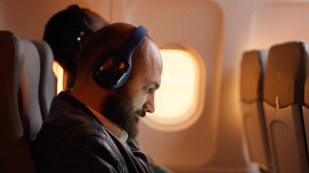 istock Businessman feeling tired and angry about work trip on plane 1439913304