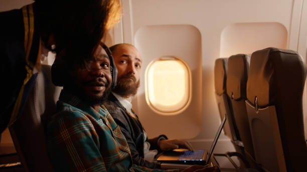 istock Tourist using mobile phone and flying on airplane jet 1439913620
