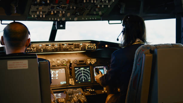 istock Team of captain and woman copilot fixing altitude and longitude 1439914128