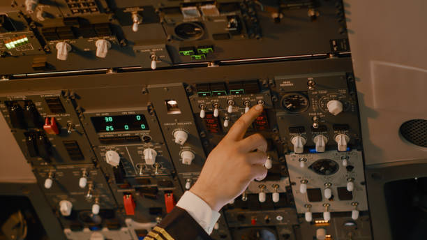 istock Male captain pushing dashboard buttons to start airplane engine 1439914193