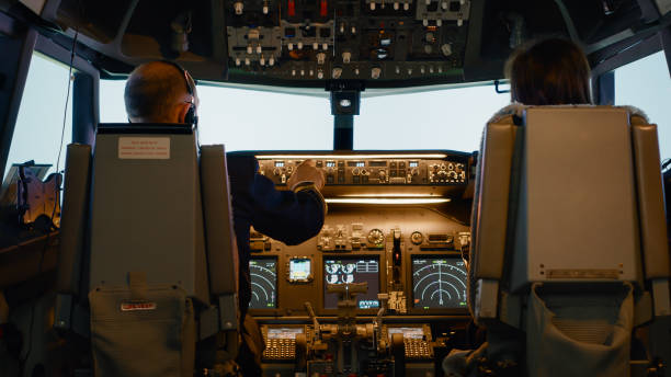 istock Captain and woman copilot in cockpit preparing to fly airplane 1439914282