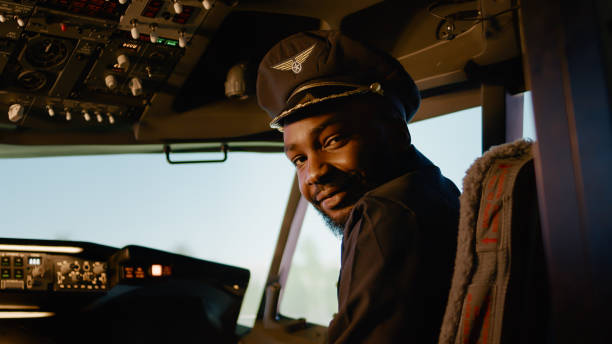 istock Portrait of male copilot pressing power switch buttons 1439914471