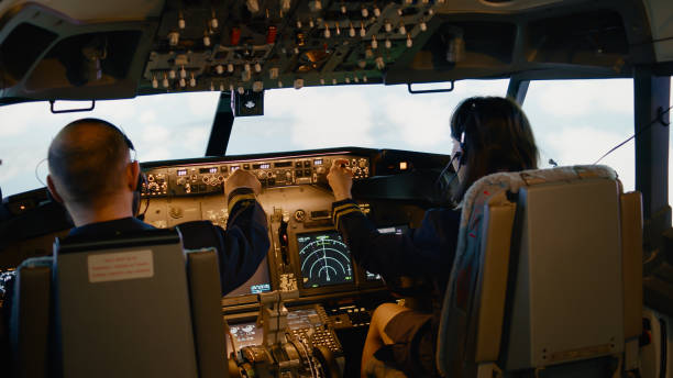 istock Team of aviators throttling power engine and fixing altitude level 1439914499