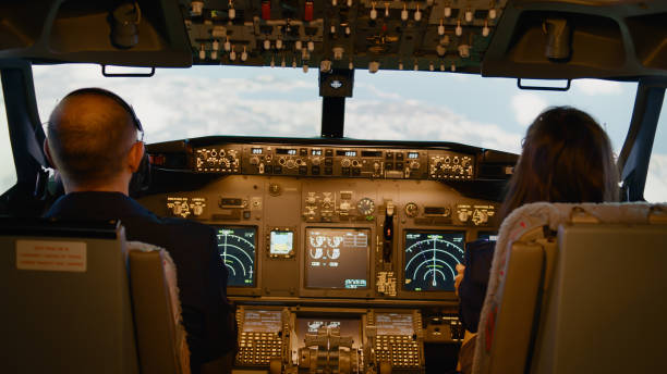 istock Pilot and woman copilot fixing altitude and longitude on dashboard 1439914528