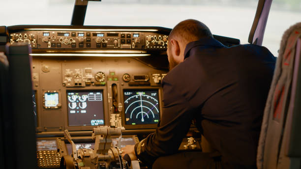 istock Aviation captain putting coordinates to fly airplane to destination 1439914536