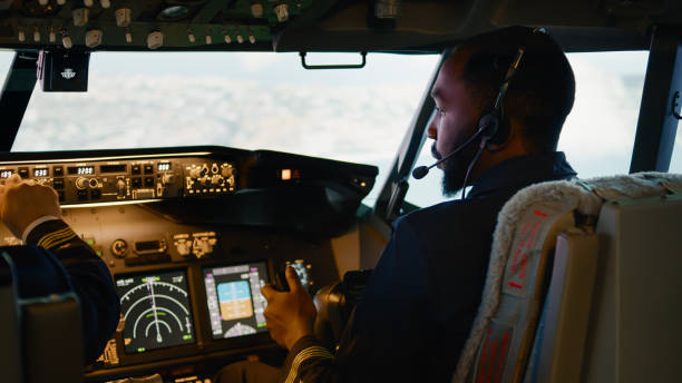 istock African american copilot flying airplane with captain in cockpit 1439914571