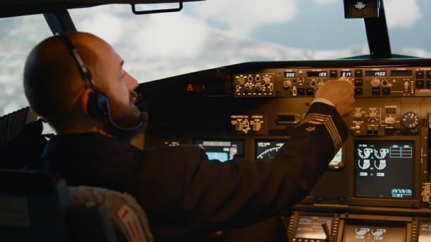 istock Airline captain fixing altitude and longitude to fly airplane 1439914576