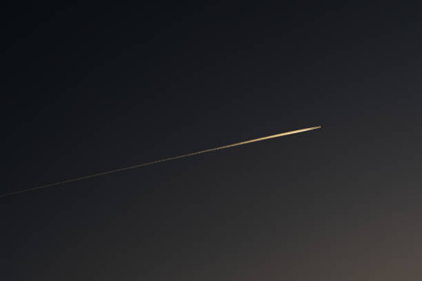 istock Dawn evening the plane draws a line across the sky 1439914641