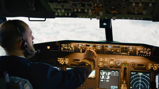 istock Airplane pilot flying aircraft fixing altitude and longitude level 1439914762