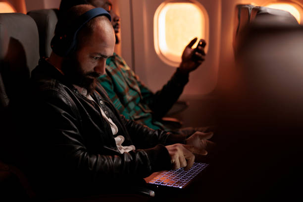 istock Diverse group of passengers flying in economy class on plane jet 1439915552