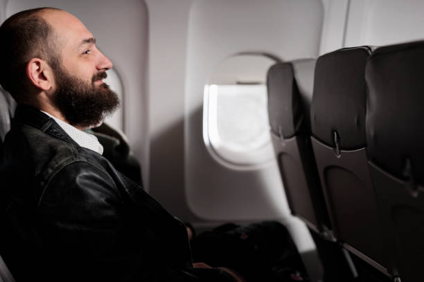 istock Passengers couple sitting in airplane waiting to takeoff 1439915569