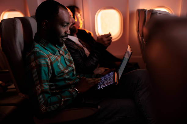 istock Modern traveller browsing internet on laptop and flying abroad 1439915664